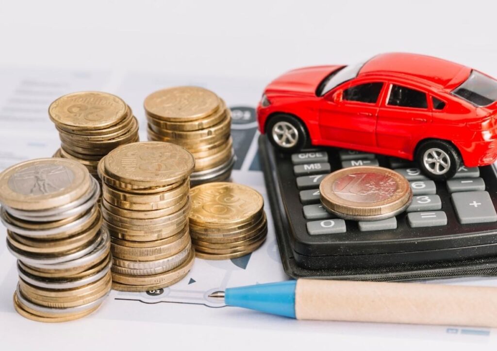 Stack of coins; calculator; toy car and pen on template