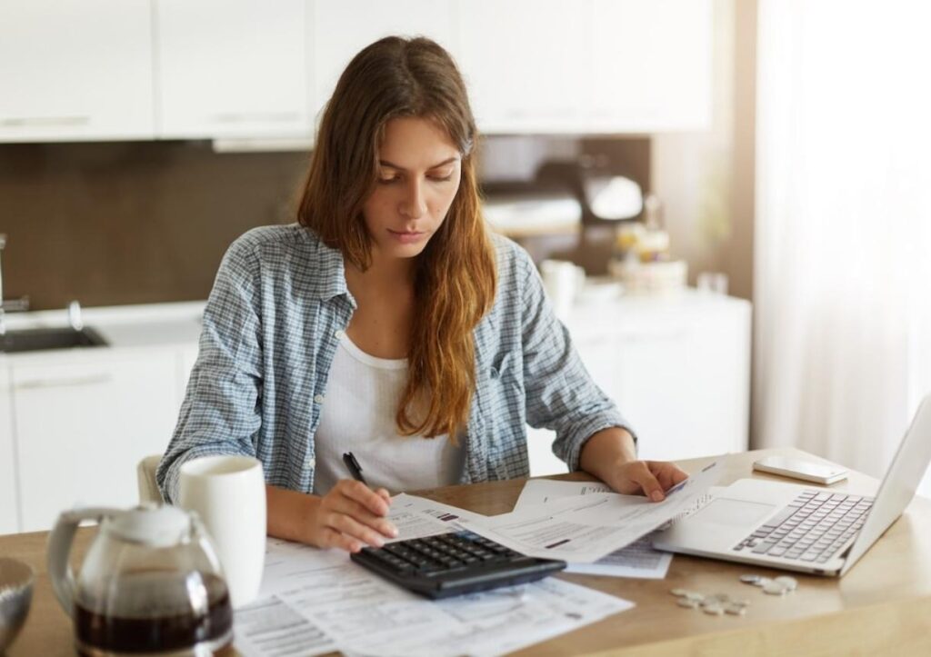 Young woman checking her budget and doing taxes