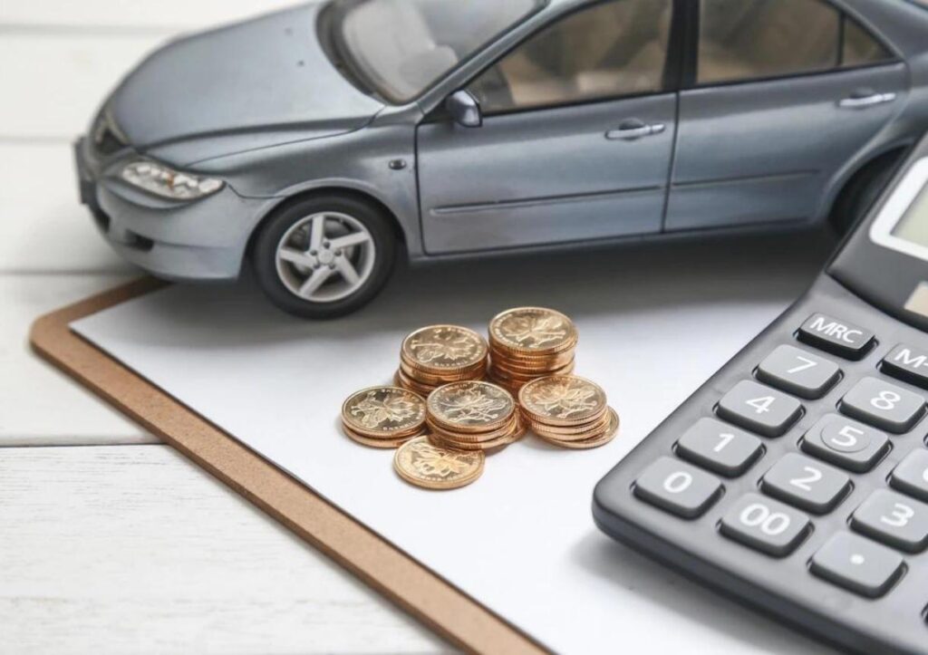 Car model calculator and coins on white table