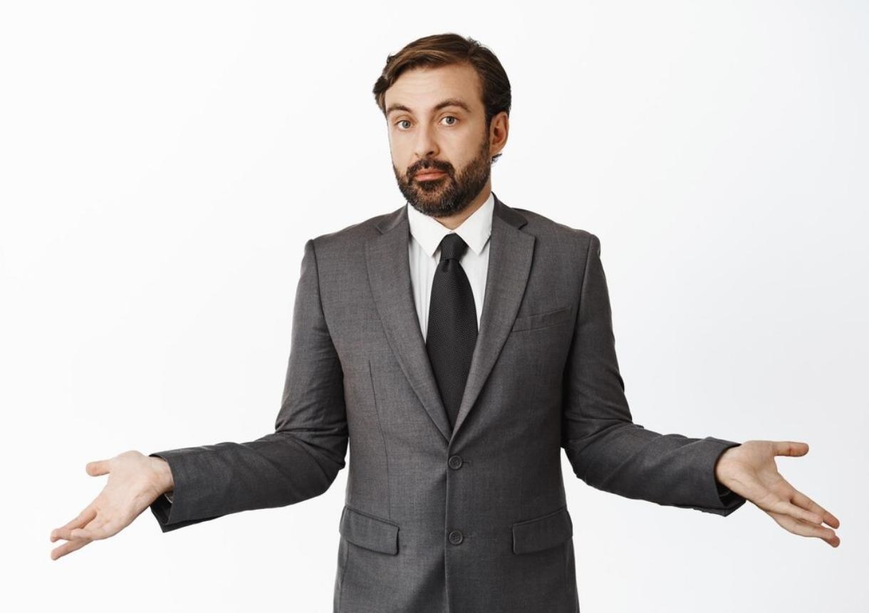 Confused corporate man spread hands sideways have nothing to say
