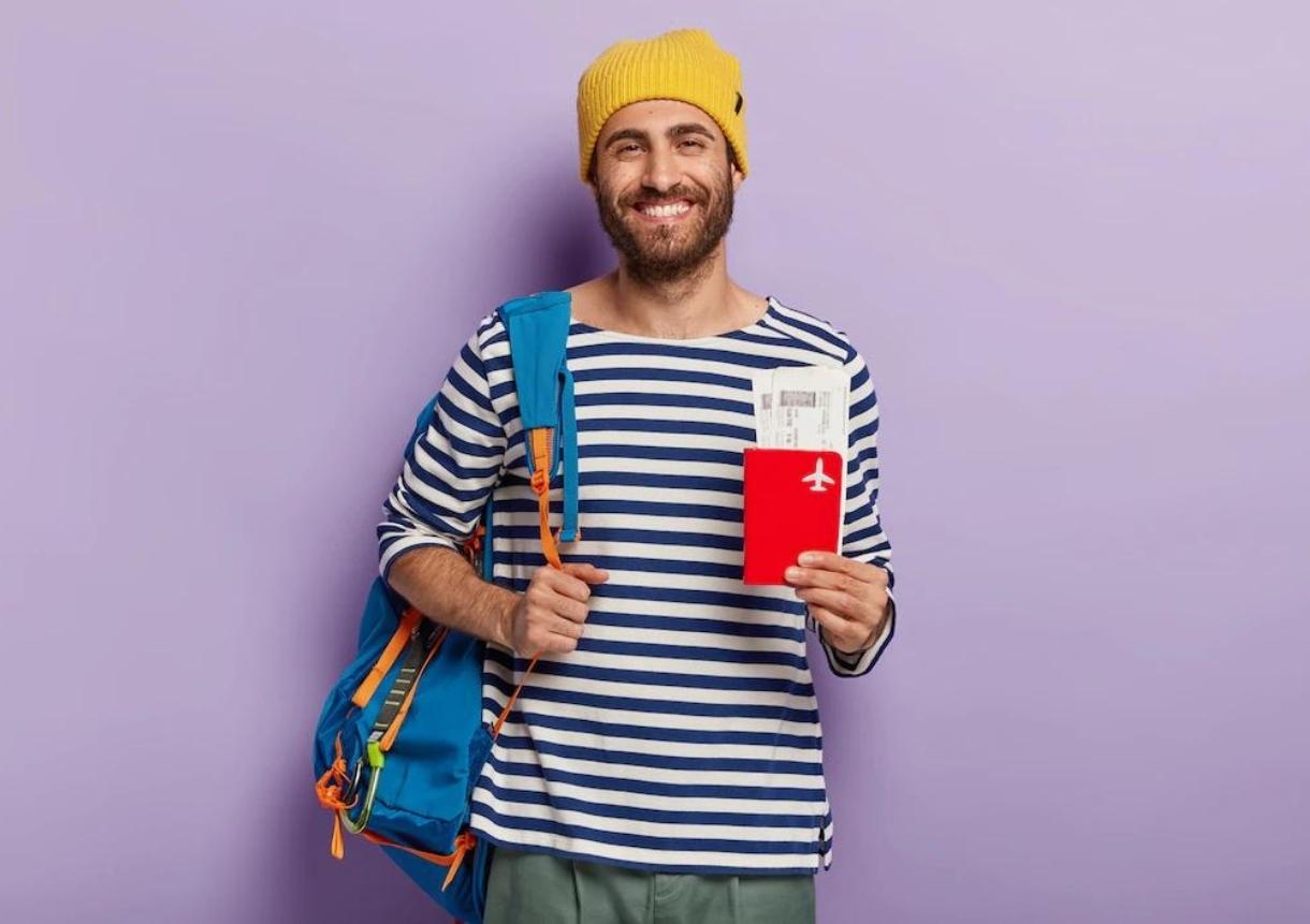 tourist holds passport and tickets