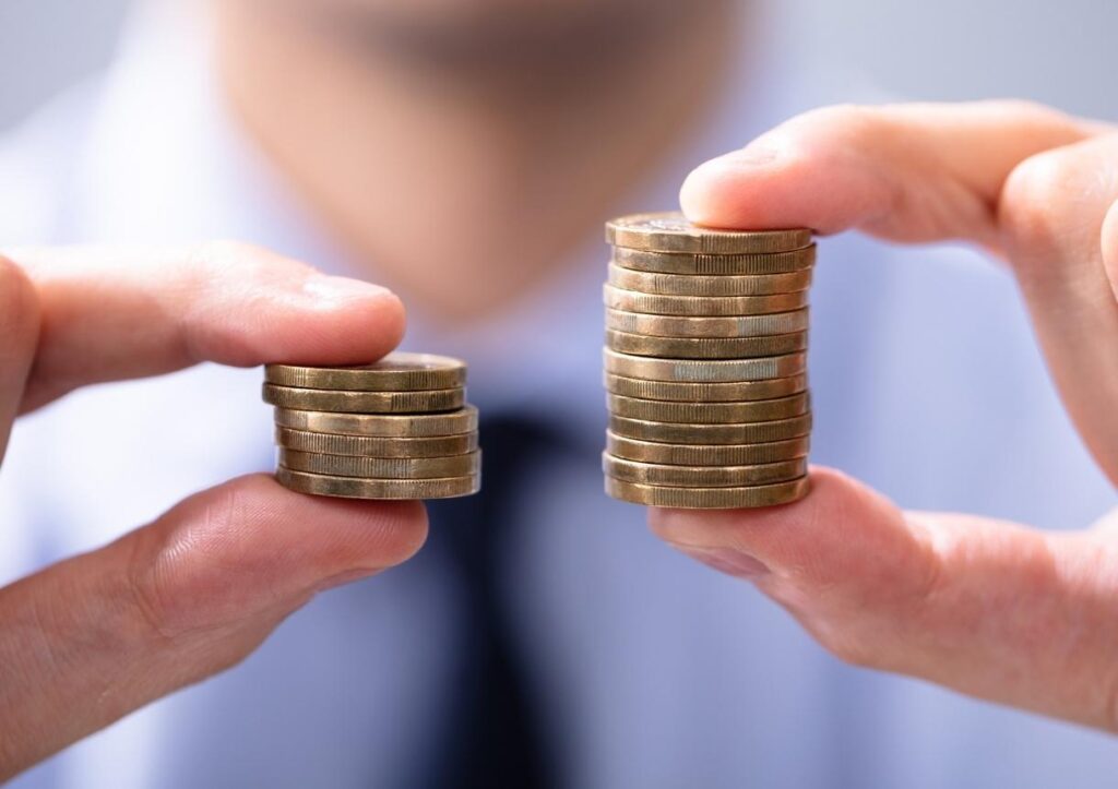 Man Comparing Two Coin Stacks