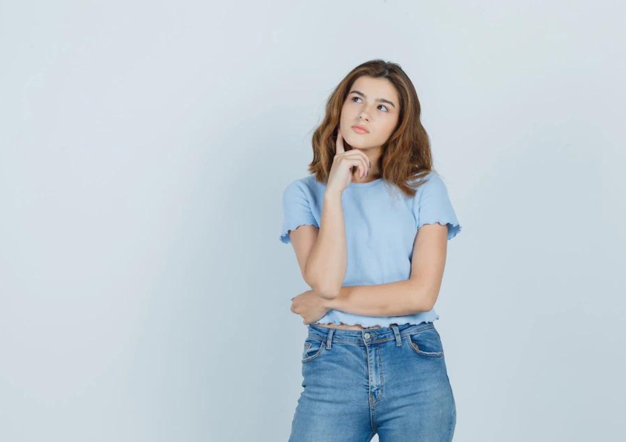 Young girl in t-shirt thinking