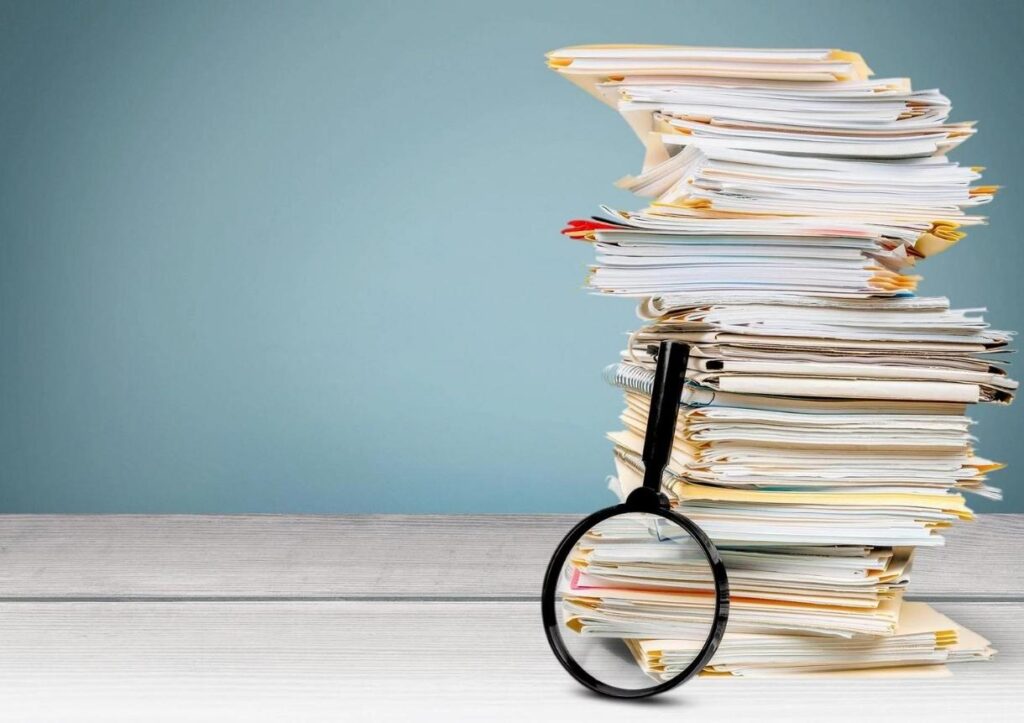 documents and magnifying glass on the desk