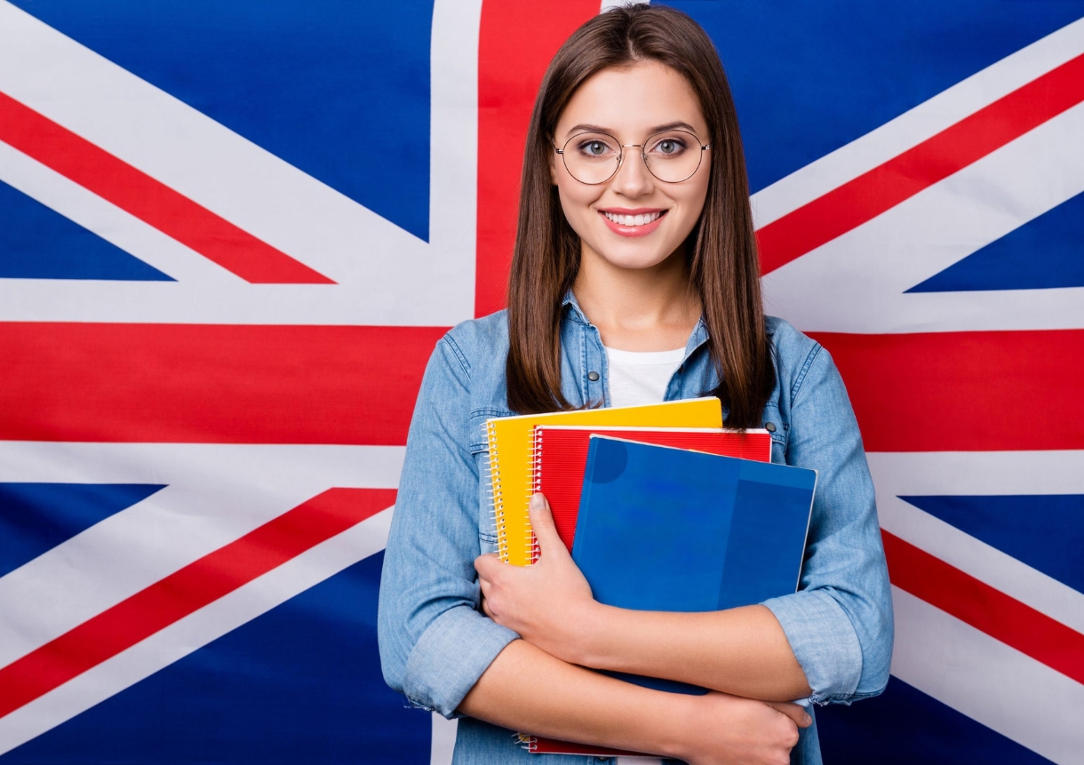 girl holding book in hands isolated over british stripes flag