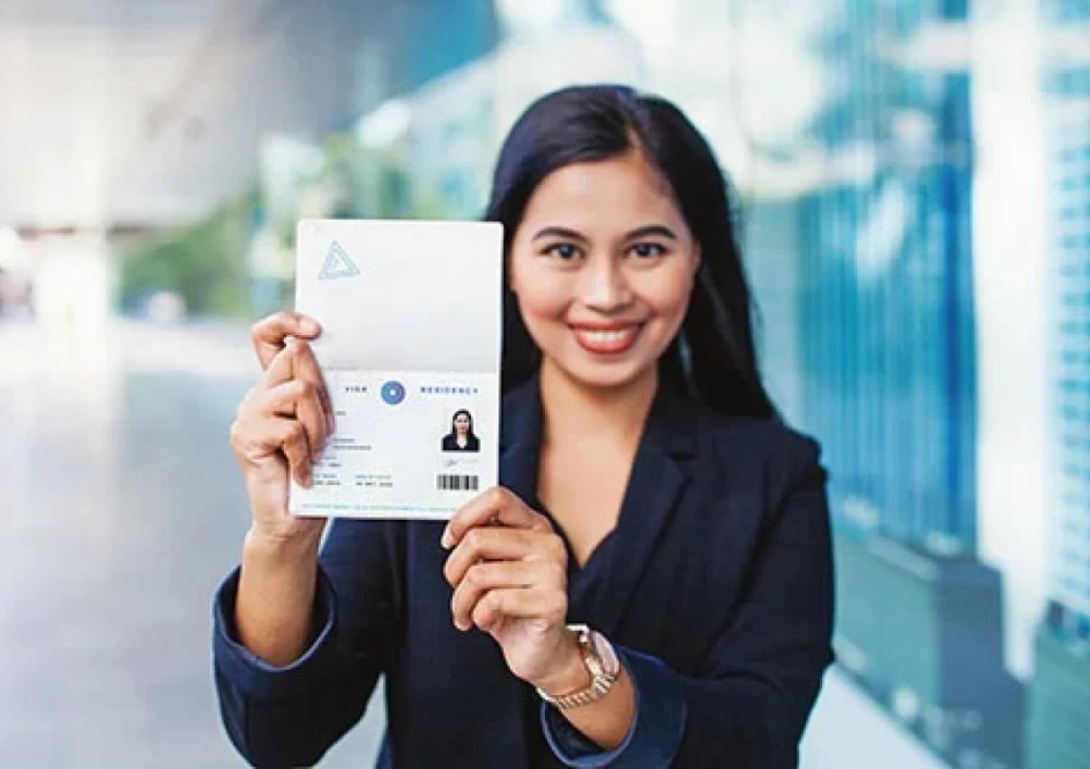 woman showing valid visa and work permit in her passport